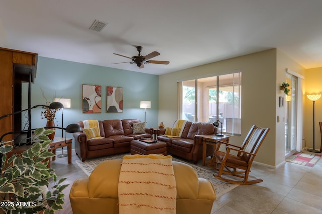 living room featuring light tile patterned floors and ceiling fan