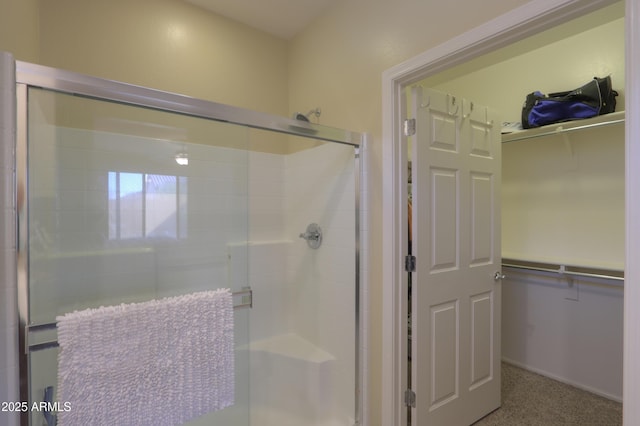 bathroom with a shower with door