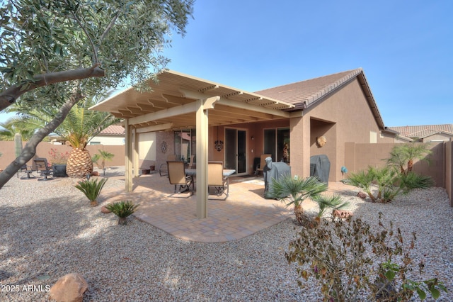 back of property with a patio