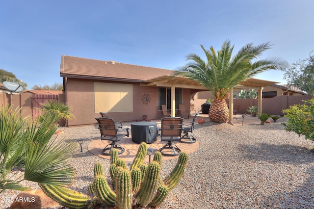 back of house with a patio and a fire pit