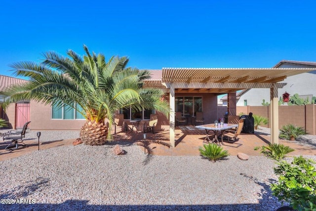 back of property with a pergola and a patio