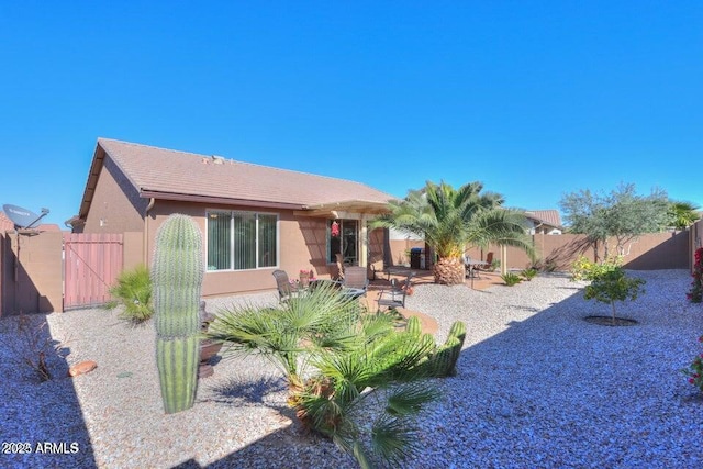 rear view of property featuring a patio