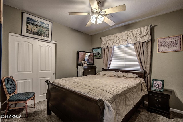 bedroom featuring ceiling fan, a closet, a textured ceiling, and dark colored carpet