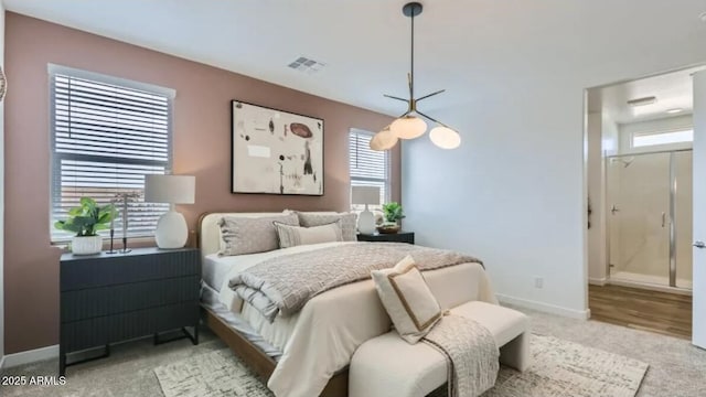 23334 W Mobile Ln, Buckeye, AZ 85326 - bedroom with light colored carpet, baseboards, and connected bathroom