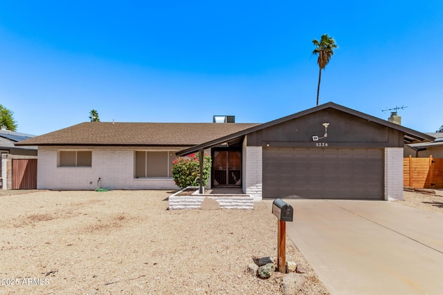 5226 W Redfield Rd, Glendale, AZ 85306 - ranch-style house with brick siding, an attached garage, driveway, and a shingled roof