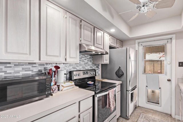 5226 W Redfield Rd, Glendale, AZ 85306 - kitchen with stainless steel appliances, under cabinet range hood, light countertops, tasteful backsplash, and recessed lighting