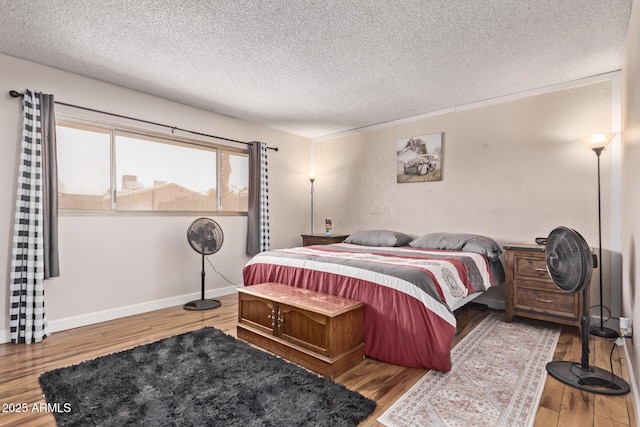 5226 W Redfield Rd, Glendale, AZ 85306 - bedroom featuring wood finished floors, a textured ceiling, and baseboards
