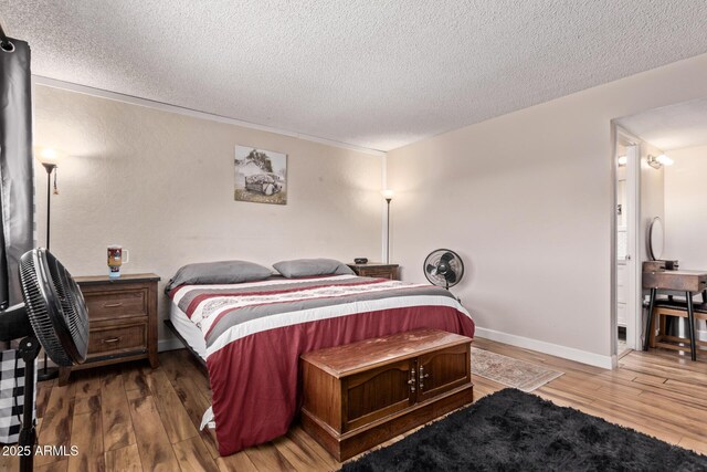 5226 W Redfield Rd, Glendale, AZ 85306 - bedroom featuring a textured ceiling, wood finished floors, and baseboards