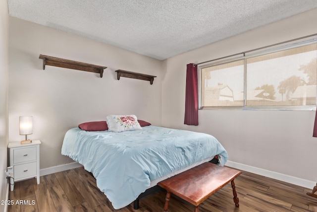 5226 W Redfield Rd, Glendale, AZ 85306 - bedroom with baseboards, a textured ceiling, and wood finished floors
