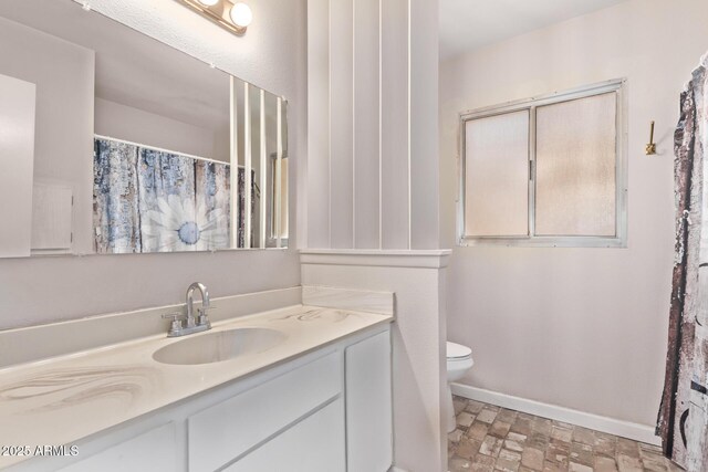 5226 W Redfield Rd, Glendale, AZ 85306 - full bathroom featuring toilet, vanity, and baseboards