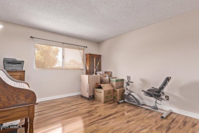 5226 W Redfield Rd, Glendale, AZ 85306 - exercise room with wood finished floors, a textured ceiling, and baseboards