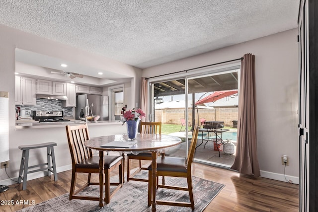 5226 W Redfield Rd, Glendale, AZ 85306 - dining area featuring wood finished floors, a textured ceiling, baseboards, and recessed lighting