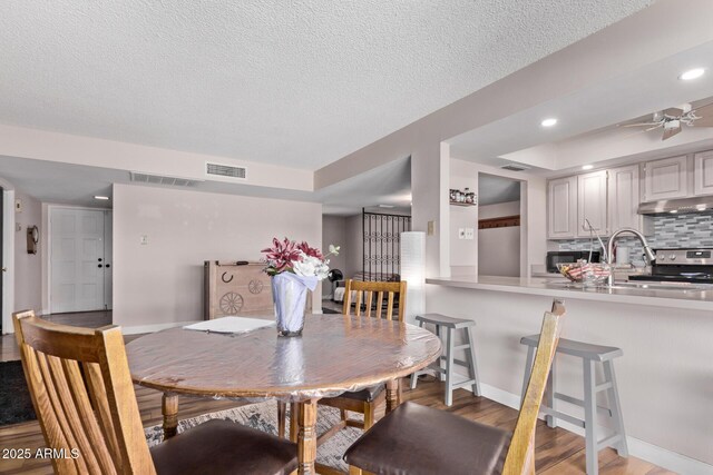 5226 W Redfield Rd, Glendale, AZ 85306 - dining space with light wood-type flooring, ceiling fan, a textured ceiling, recessed lighting, and baseboards