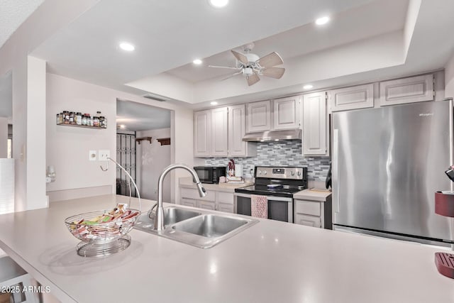 5226 W Redfield Rd, Glendale, AZ 85306 - kitchen featuring stainless steel appliances, a sink, under cabinet range hood, a ceiling fan, and decorative backsplash