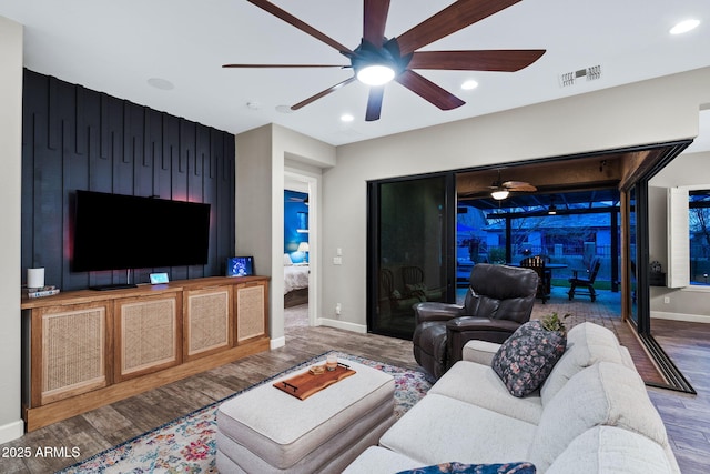 living room with a ceiling fan, wood finished floors, visible vents, baseboards, and recessed lighting