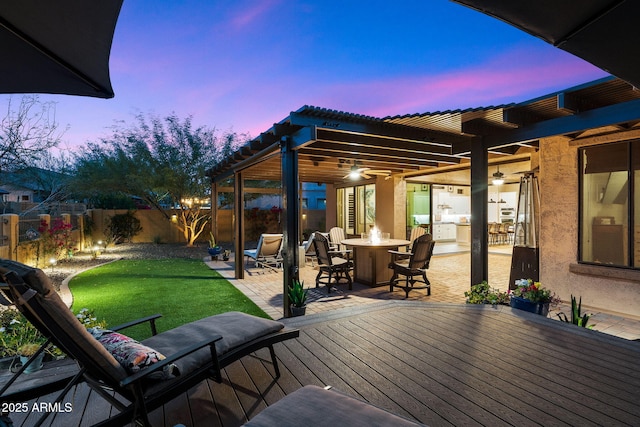 wooden deck featuring a patio, a yard, fence, and an outdoor fire pit