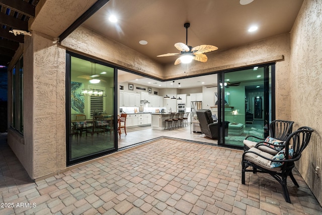 view of patio with an outdoor kitchen and a ceiling fan