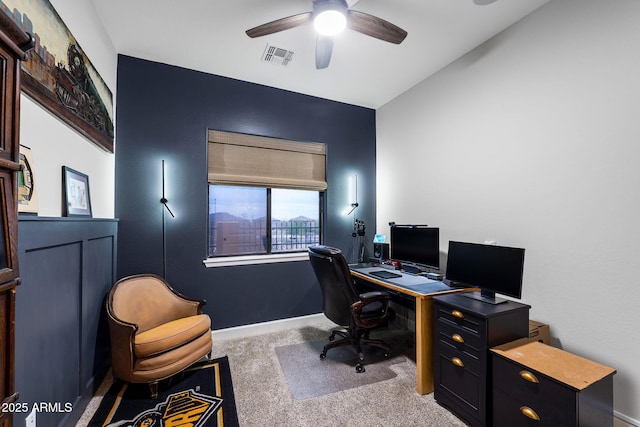 office space featuring visible vents, baseboards, ceiling fan, and carpet floors