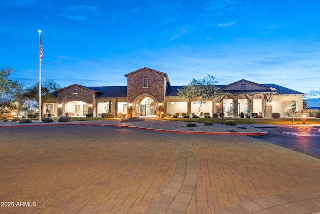 view of building exterior featuring curved driveway