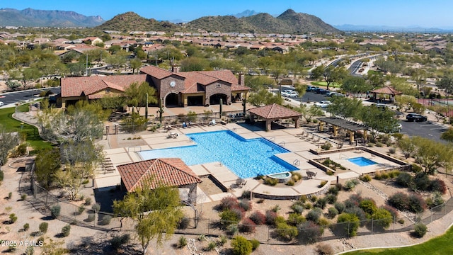 community pool with a patio, fence, a mountain view, a pergola, and a residential view