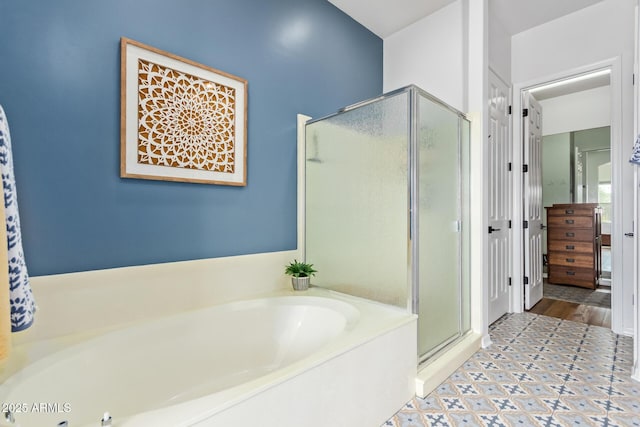 full bath featuring a bath, tile patterned floors, and a stall shower