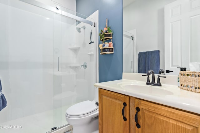 full bathroom with a shower stall, toilet, and vanity