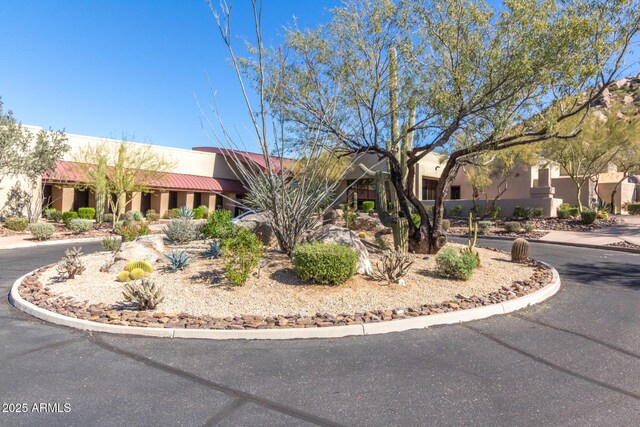 southwest-style home with stucco siding and a tile roof