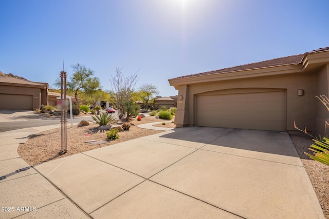 garage featuring concrete driveway