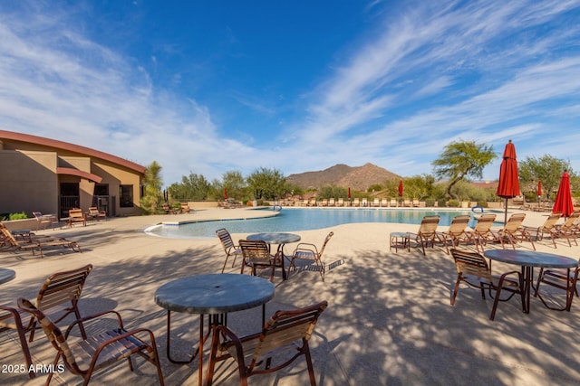 community pool featuring a patio area and a mountain view