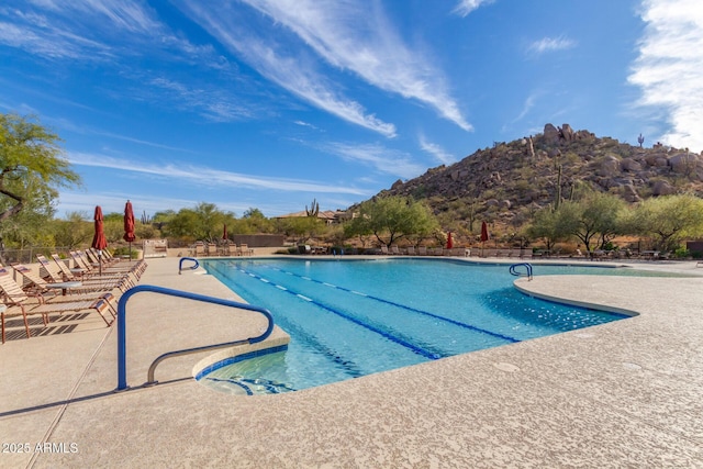 pool featuring a mountain view and a patio