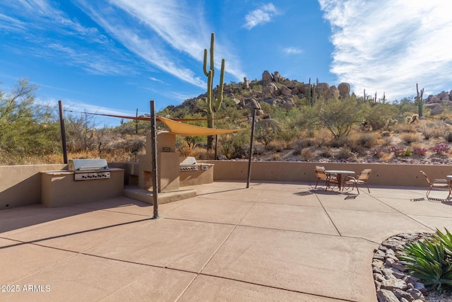 view of patio with area for grilling and exterior kitchen