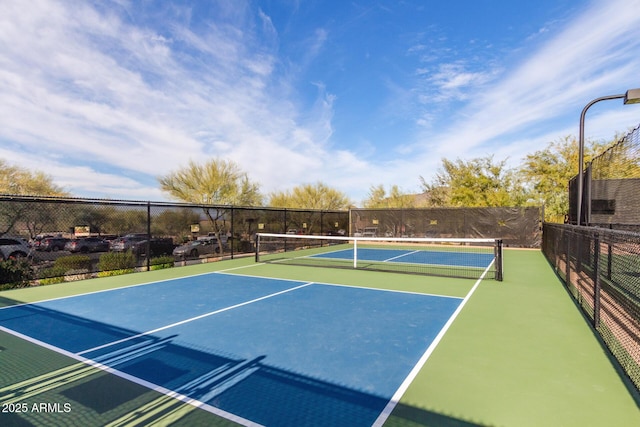 view of tennis court with fence