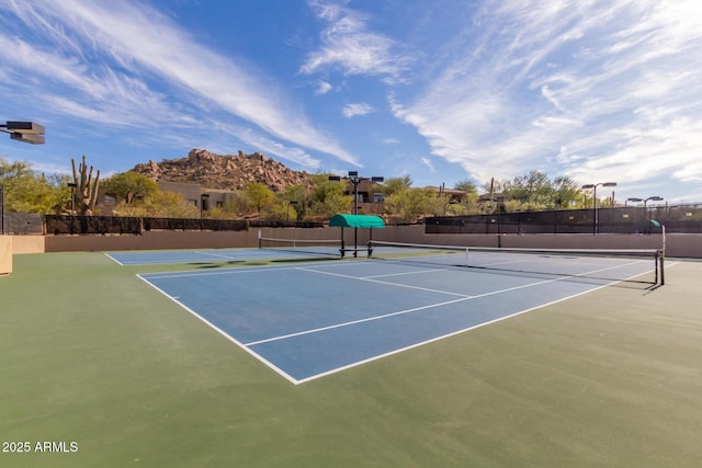 view of tennis court with fence