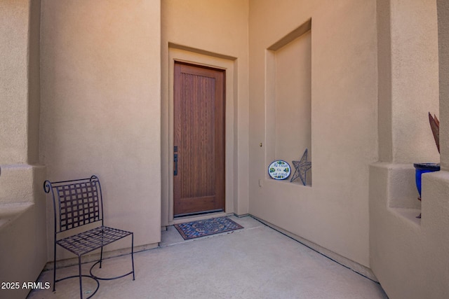 doorway to property with stucco siding