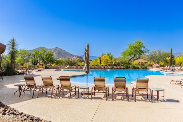 pool featuring a patio and a mountain view