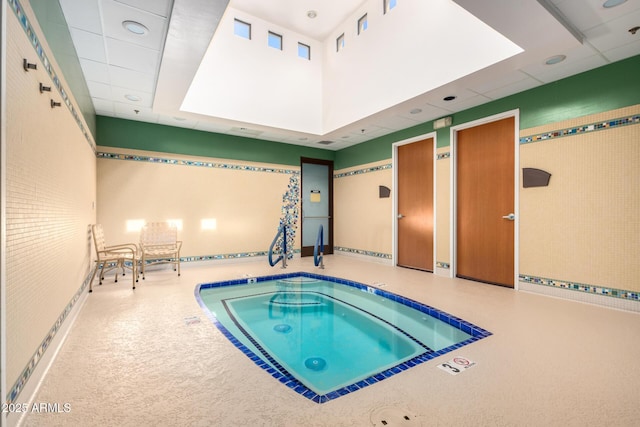 view of swimming pool with an indoor hot tub