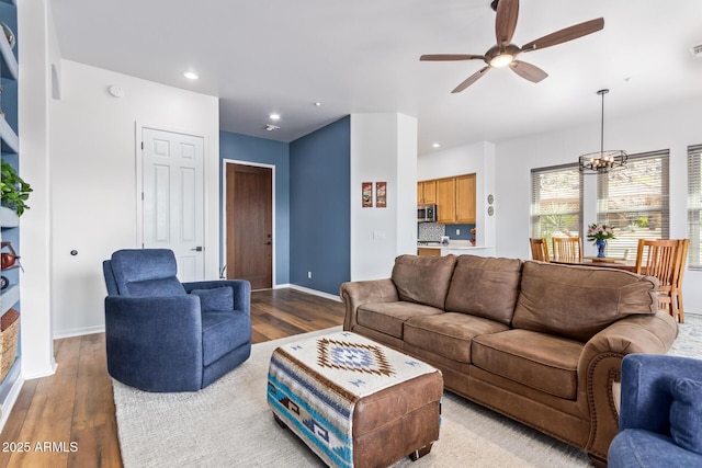 living room featuring recessed lighting, wood finished floors, and baseboards