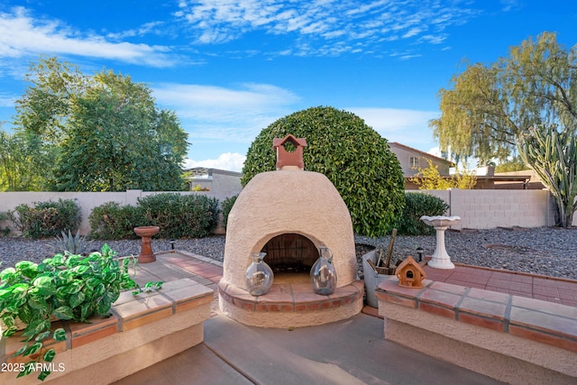 view of patio featuring an outdoor fireplace