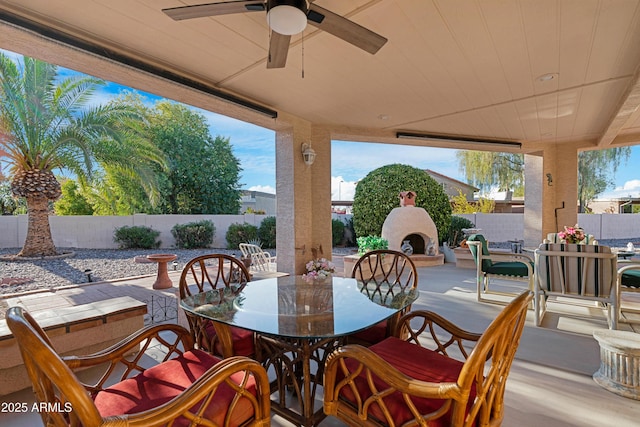 view of patio featuring ceiling fan and an outdoor fireplace