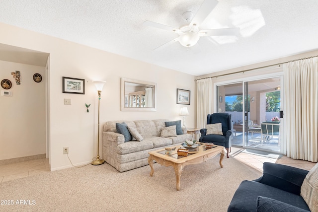 carpeted living room with ceiling fan and a textured ceiling