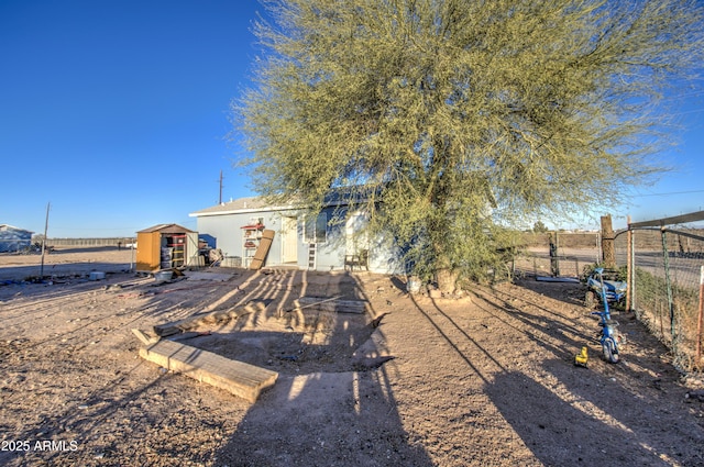 exterior space featuring an outdoor structure and fence