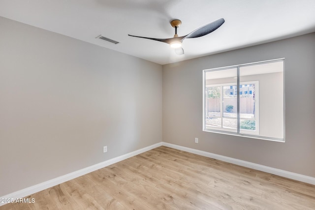 unfurnished room featuring light wood finished floors, baseboards, and visible vents