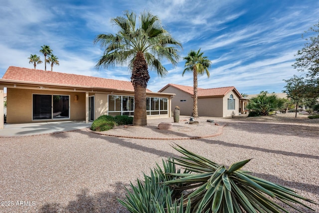 view of front of property with a sunroom and stucco siding