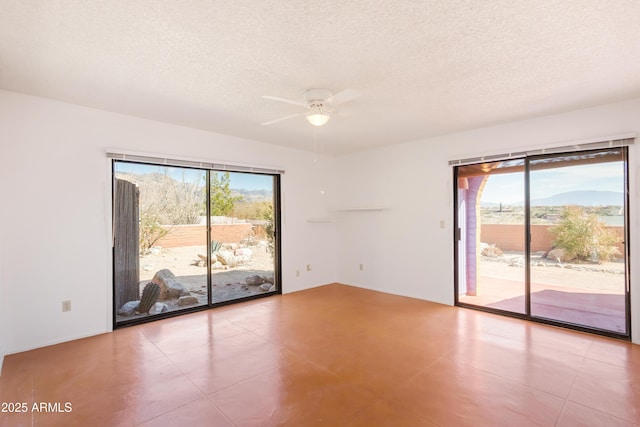 spare room with ceiling fan, a textured ceiling, and a wealth of natural light