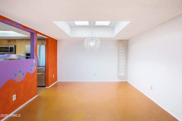 interior space featuring a skylight, baseboards, a tray ceiling, a textured ceiling, and a notable chandelier