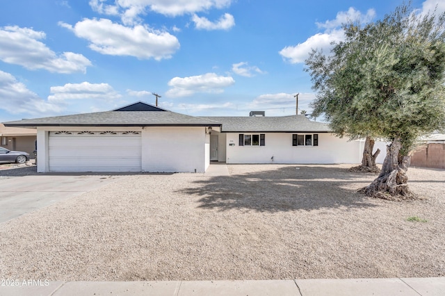 ranch-style house with a garage, concrete driveway, and brick siding