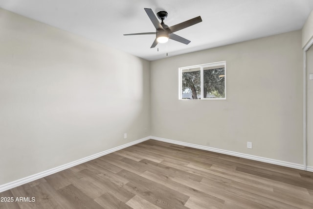 empty room with light wood-style flooring, baseboards, and ceiling fan