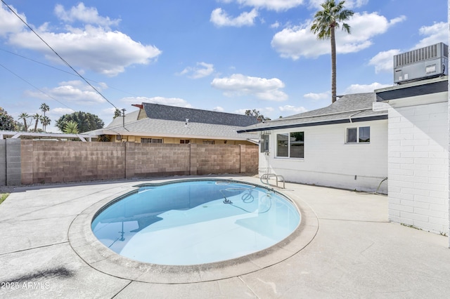 view of swimming pool featuring a fenced in pool, fence, and central air condition unit