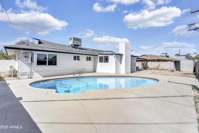 view of pool with a patio, fence, a fenced in pool, and central air condition unit