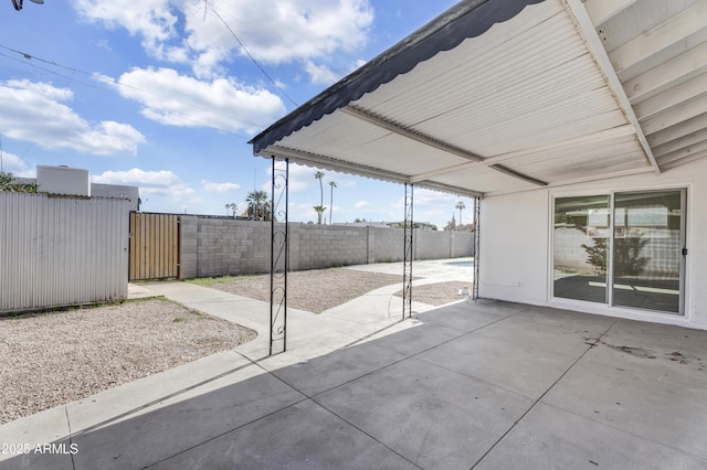 view of patio with a gate and fence